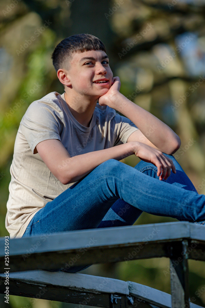 Obraz premium Teenage boy outside on a bright Spring day