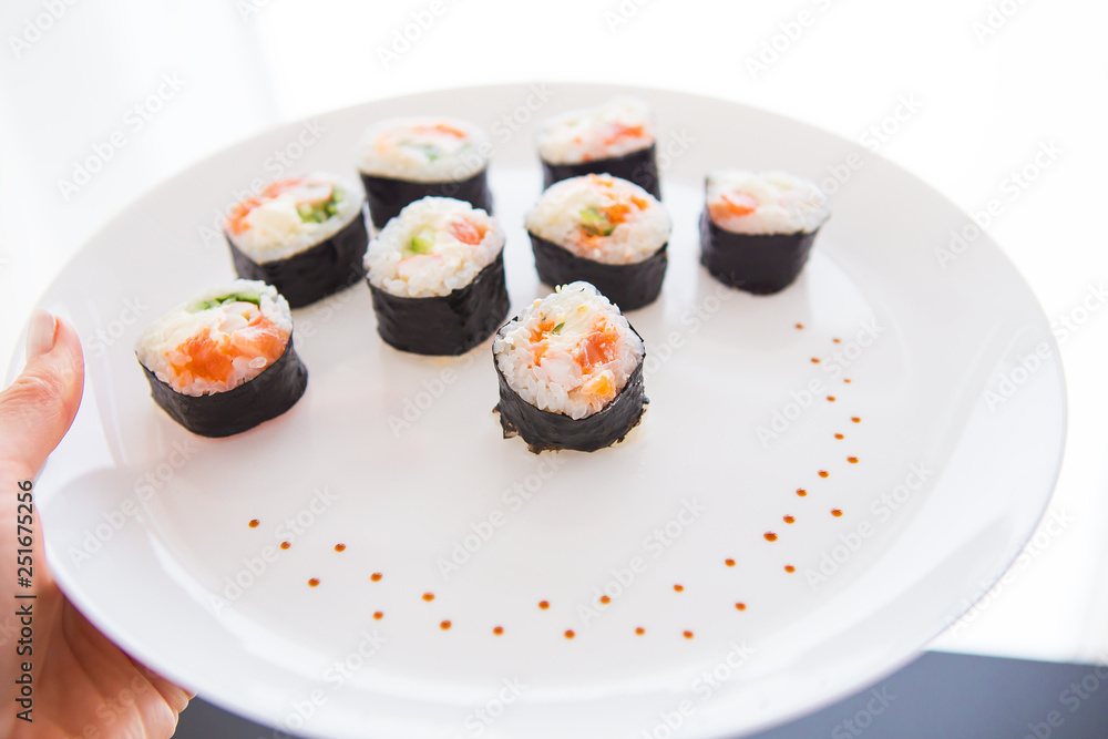 Delicious fresh sushi on a white plate, closeup. View from above. Delicious fresh sushi on a white plate, closeup. View from above.