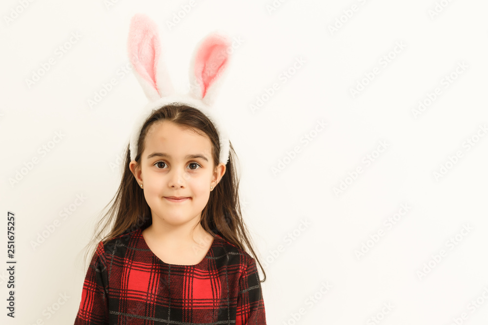 Surprised little girl wearing bunny ears, lying on light on Easter Holiday. Surprised little girl wearing bunny ears, lying on light on Easter Holiday.