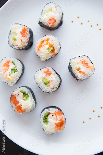 Delicious fresh sushi on a white plate, close-up.