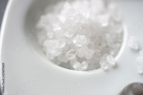 large white sea salt scattered on a light saucer