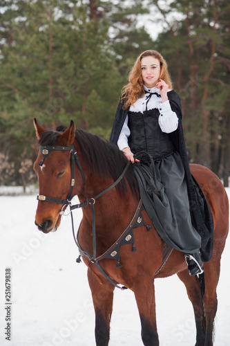 Beautiful girl in historical clothes riding a horse © Rakursstudio
