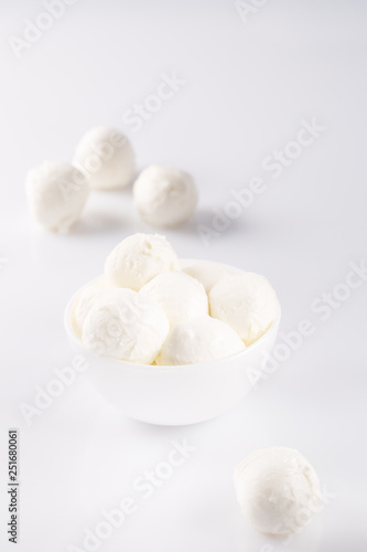 Fresh mozzarella in a bowl on white background