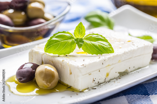 Greek cheese feta with olive oil olives and basil leaves