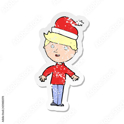 retro distressed sticker of a cartoon boy in santa hat © lineartestpilot