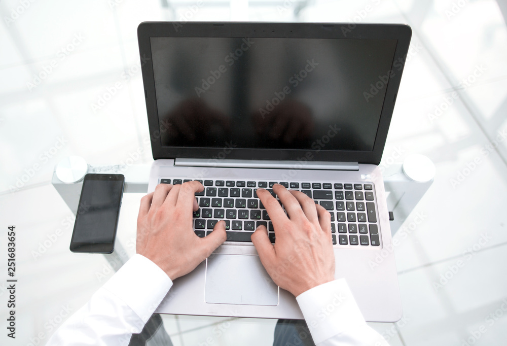 rear view.businessman typing on a laptop. rear view.businessman typing on a laptop.