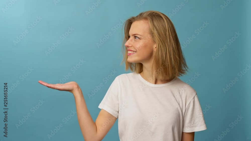 Lovely model doing a hand gesture on imaginary object on top of her hand Lovely model doing a hand gesture on imaginary object on top of her hand