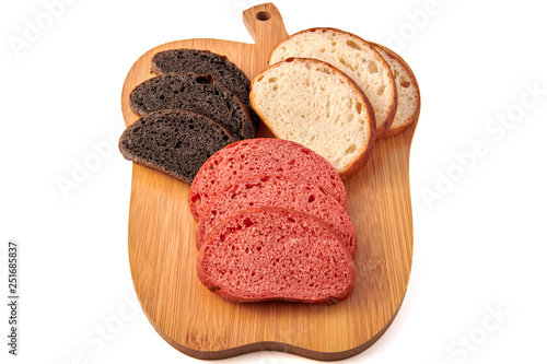 Colored hamburger buns cut slices on little wooden cutting boardand isolated on white background