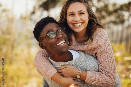 Interracial couple having fun outdoors photo