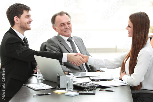 business woman shaking hands with an adult business partner.