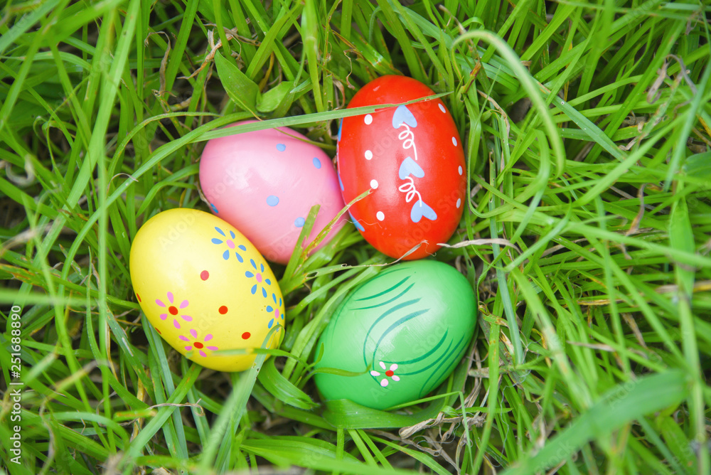 Easter eggs hunt on green grass meadow outdoor Easter eggs hunt on green grass meadow outdoor