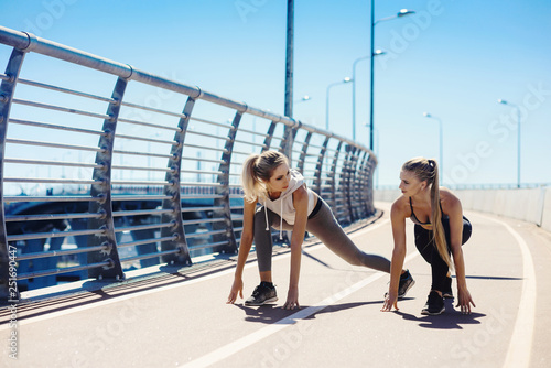 Young sexy girls models runs in the city on the modern bridge in the morning. Workout fitness healthy lifestyle concept