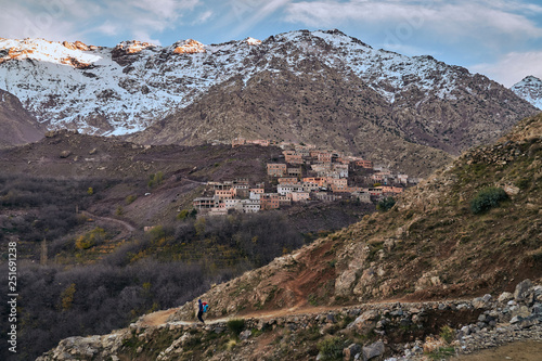 A view of sunset and touristic path in rural mountain village in High Atlas mountains Morocco Africa with snow covered peaks