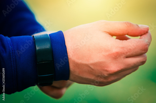 Close up of a male person wearing a  fitness tracker