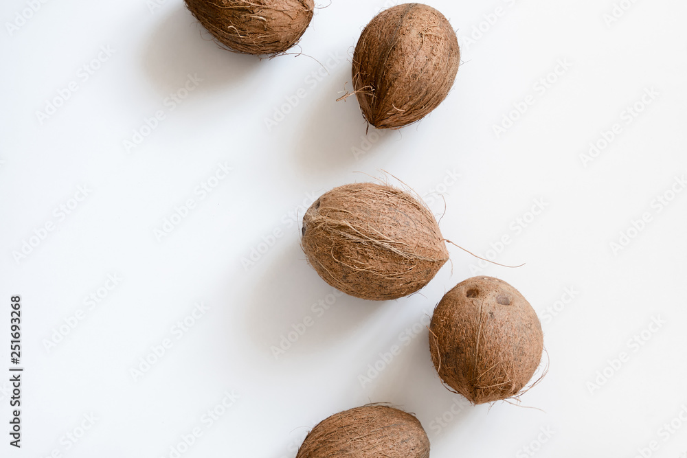Summer fruit composition. Coconut on white background. Creative summer concept. Flat lay, top view, copy space Summer fruit composition. Coconut on white background. Creative summer concept. Flat lay, top view, copy space