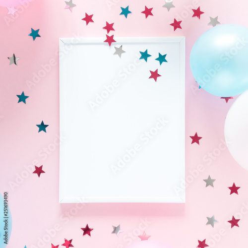 Festive pink background. Shining stars, photo frame and balloons on light pink pastel background. Birthday holiday concept. Flat lay, top view, copy space