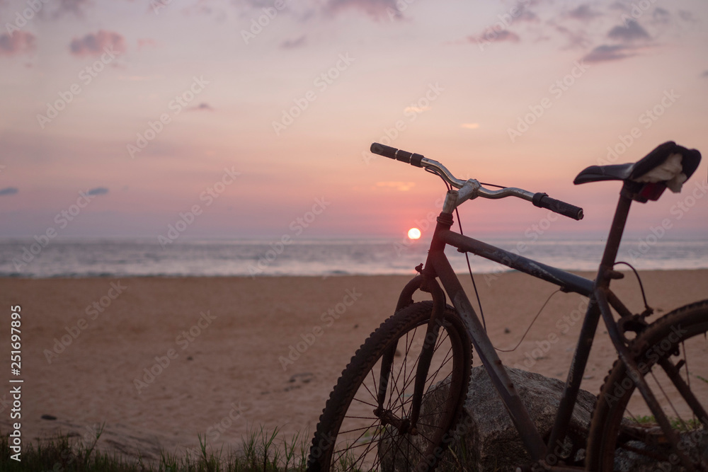 Fototapeta premium Bike on the beach, sea, sunset.