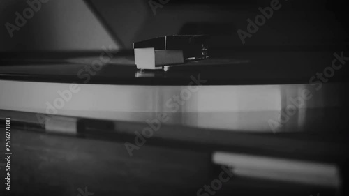 Vinyl record spinning on the turntable in black and white
