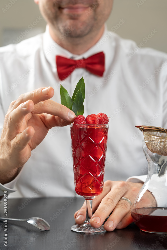 classy fancy bartender mixologist makes prepares alcohol drink cocktail bowtie raspberry