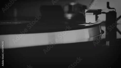Vinyl record spinning on the turntable in black and white