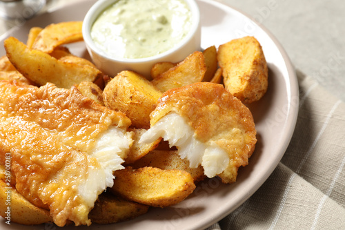 Plate with British Traditional Fish and potato chips on grey background, closeup