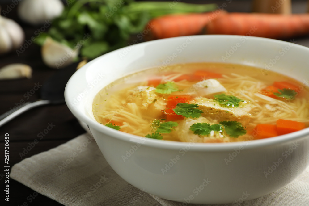 Plate with fresh homemade chicken soup on table, closeup Plate with fresh homemade chicken soup on table, closeup