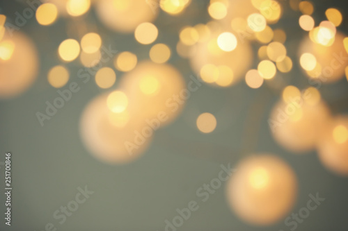 Blurred view of shiny gold lights. Bokeh effect