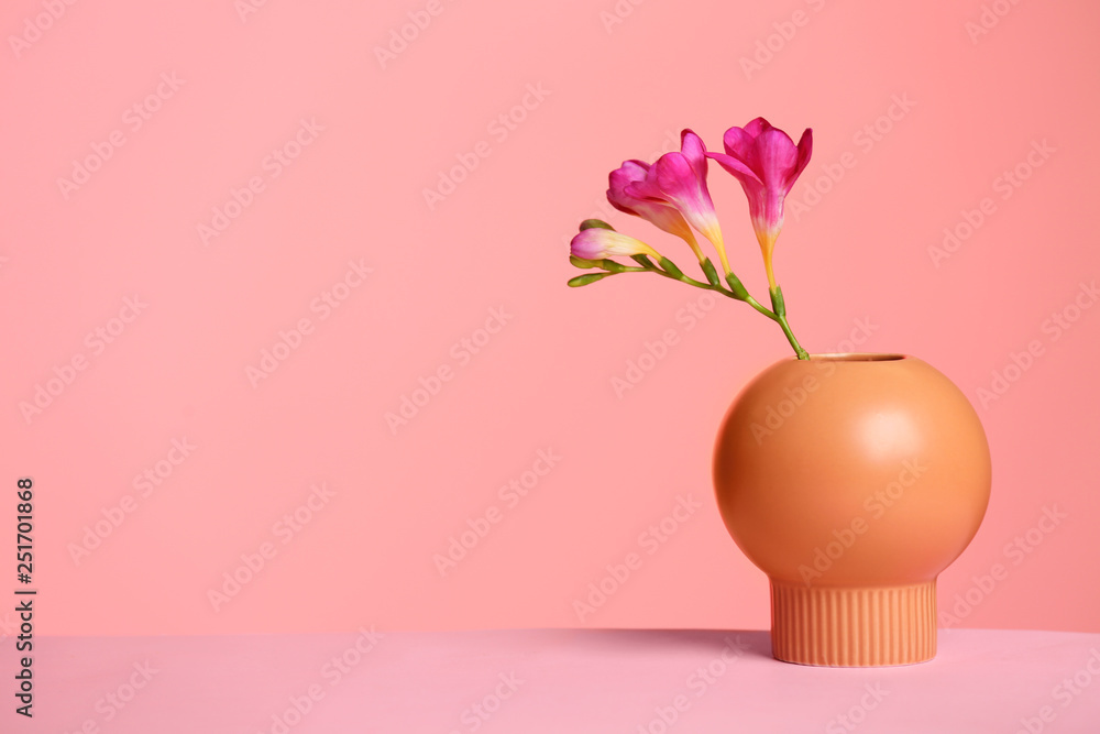 Stylish vase with beautiful flower on table against color background, space for text - obrazy, fototapety, plakaty 