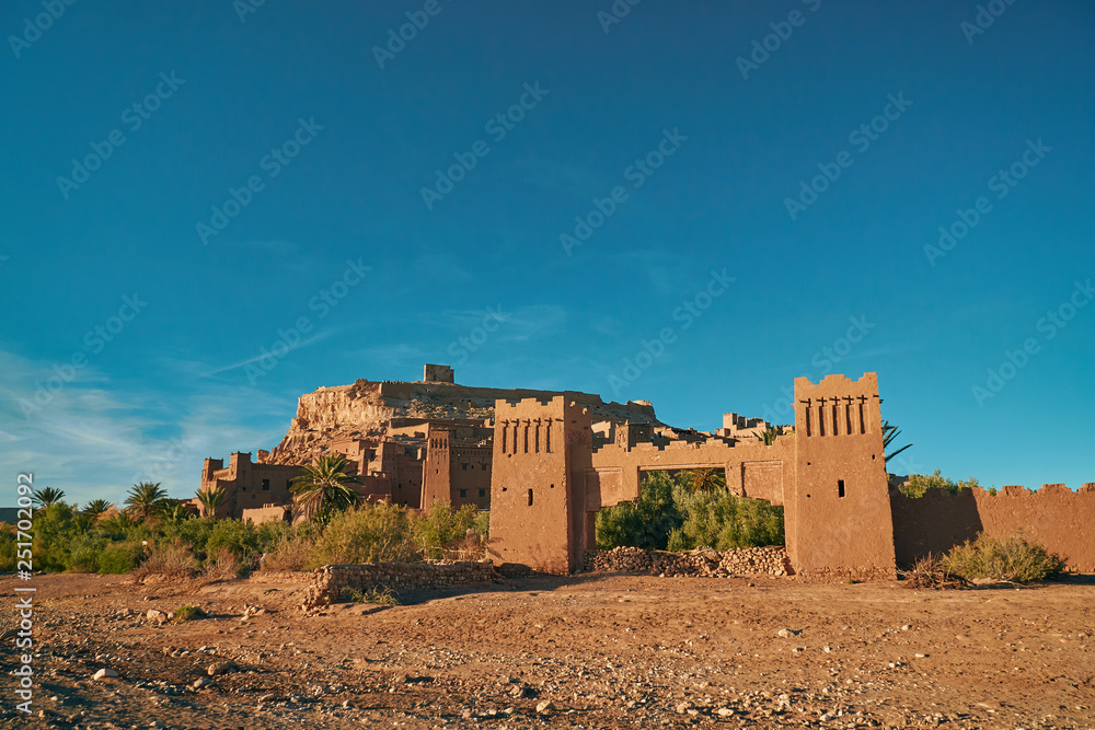 Entrance gate to historic unesco heritage ksar of Ait Ben Haddou in Morocco Africa with stones in the foreground