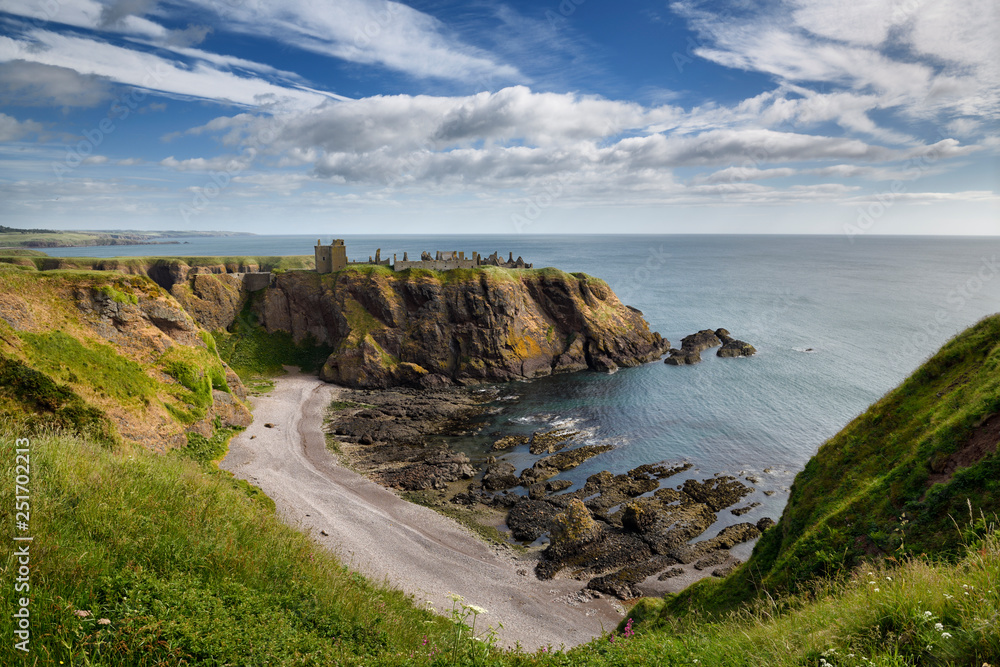 Pebble beach at Old Hall Bay North Sea from clifftop south of Donnottar Castle Medieval fortress ruins near Stonehaven Scotland UK