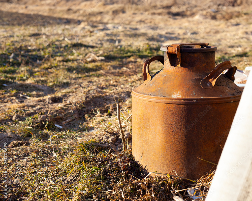an old rusty barrel with a lid in which fresh milk was transported many years ago an old rusty barrel with a lid in which fresh milk was transported many years ago