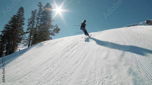 EXTREME ACTION Skier hits huge jump and throws cool trick. Blonde ski pro jump extreme trick in sunny mountains action. Big mountain groomed terrain park at California ski resort