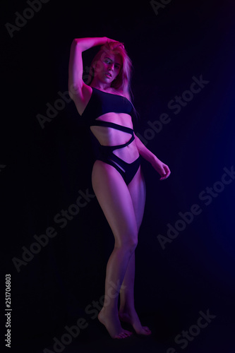 Pole dance girl with perfect body in black sexy lingerie. Night club concept