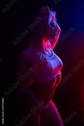 Pole dance girl with perfect body in black sexy lingerie. Night club concept