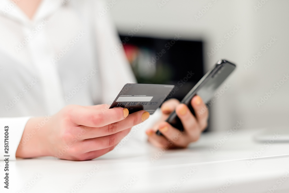 Young businesswoman making online payments using credit card and internet on the laptop in the office