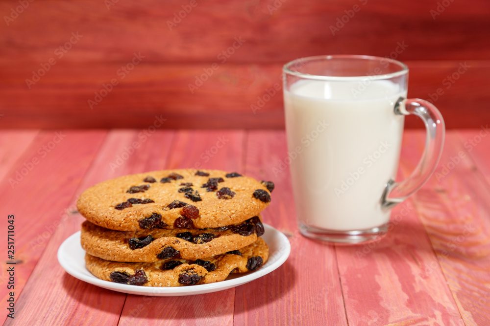 Oatmeal cookies and a glass of milk on a wooden background. Oatmeal cookies and a glass of milk on a wooden background.