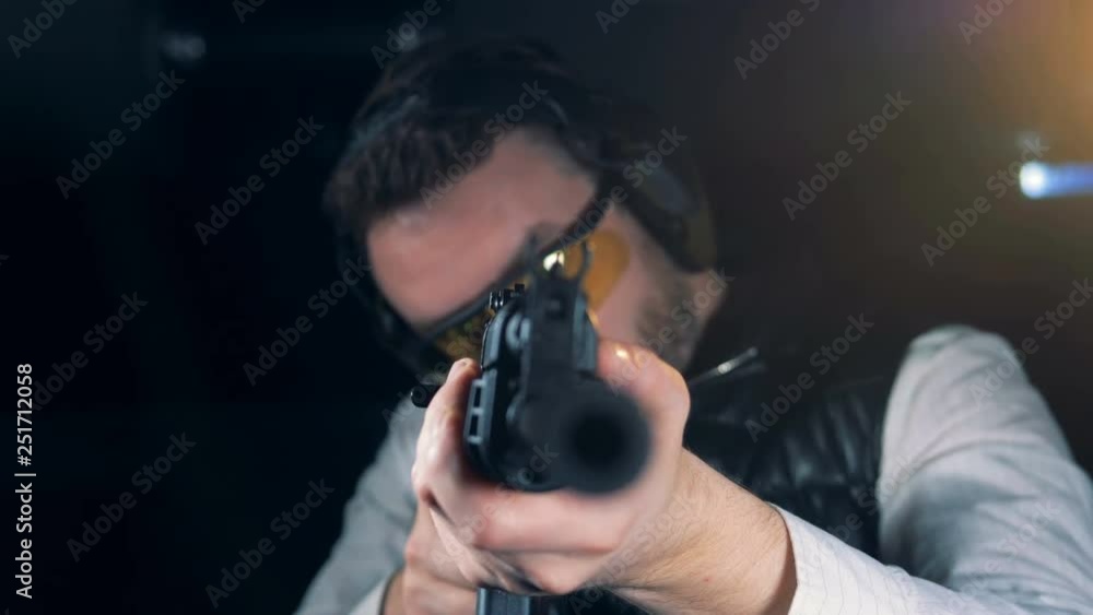 Person with a training rifle in a room, close up. Person with a training rifle in a room, close up.