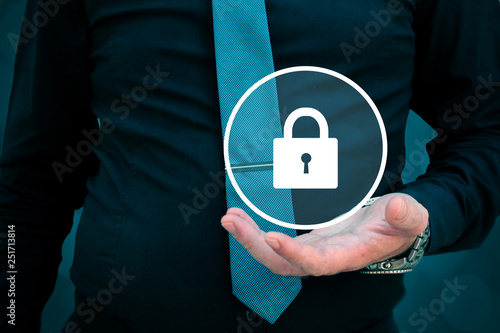 security concept, businessman holding lock in his hand photo