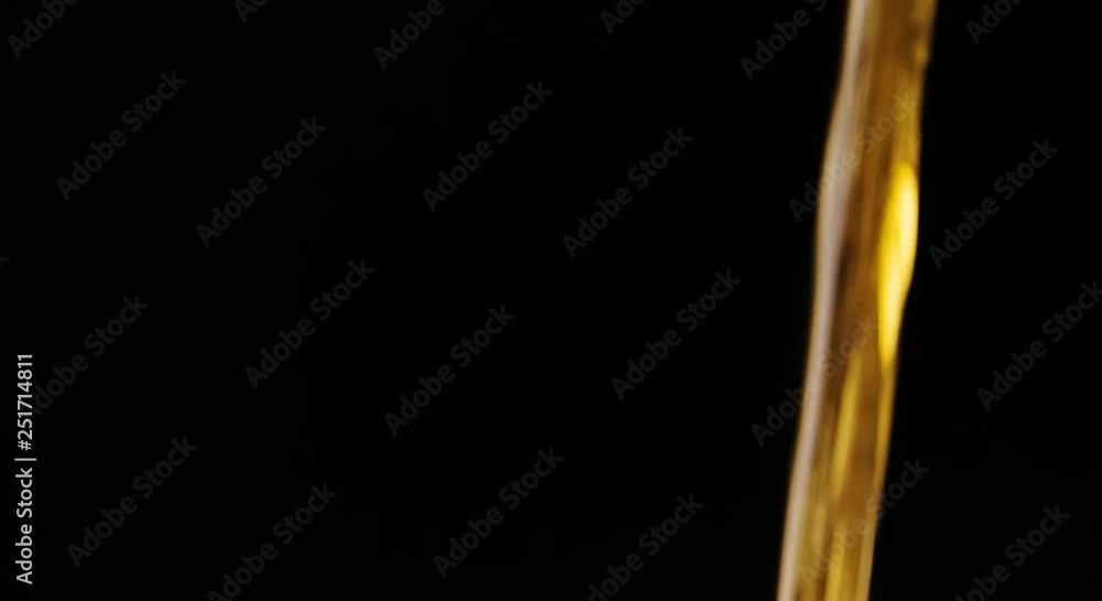 Flowing Yellow Liquid Beer Oil on Black background Slow motion abstract video Flowing Yellow Liquid Beer Oil on Black background Slow motion abstract video