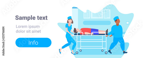 male female doctors moving patient in hospital bed stretcher medical mix race staff in uniform transporting man to operation copy space full length horizontal