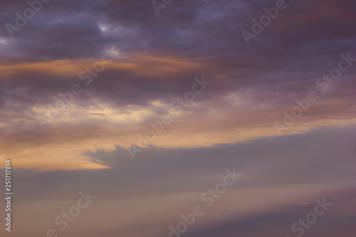 Purple sky with flat clouds as background. © Koirill