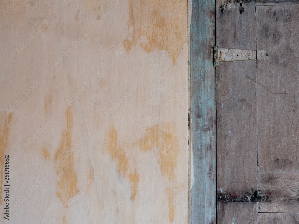 Background, texture of old plaster and painted wood. shutters on the facade