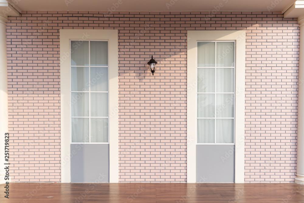 Fototapeta premium empty wooden floor with soft pink brick wall.