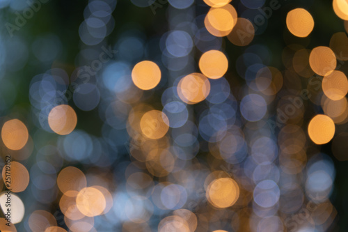Abstract orange and white lights bokeh background at christmas tree. © 9Air