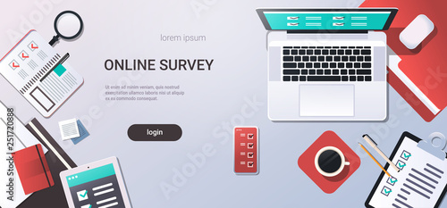 workplace desk online testing questionnaire form survey concept internet quiz laptop computer top angle view office stuff flat copy space horizontal