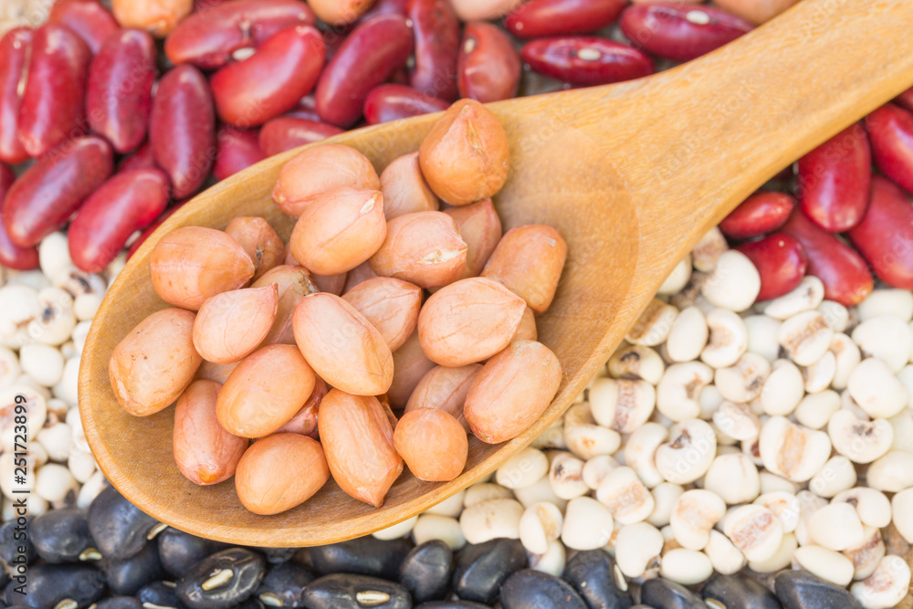Close up seasoned peanuts with wooden spoon Close up seasoned peanuts with wooden spoon