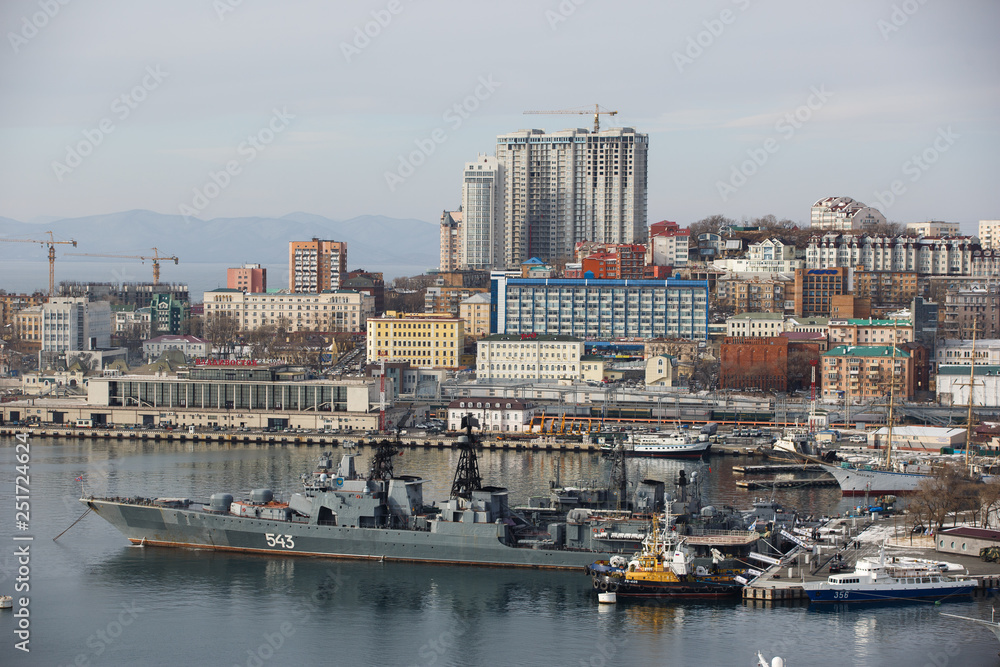 2013 - Sea facade in the capital of the Far East, the city of Vladivostok. Sea trading port with ships. Drifting ships in the raid.	