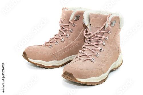 Women's winter boots made of genuine pink leather with fur on an isolated background. Winter footwear 