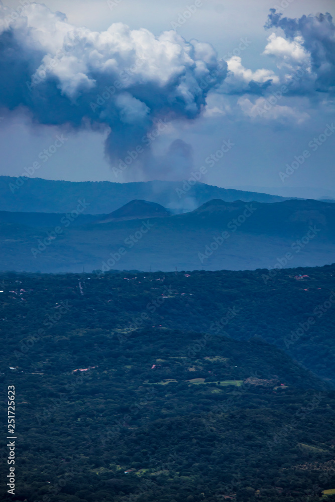 Steam Rises from the Masaya Volcano in the Distance with Farms Lining the Way in Nicaragua