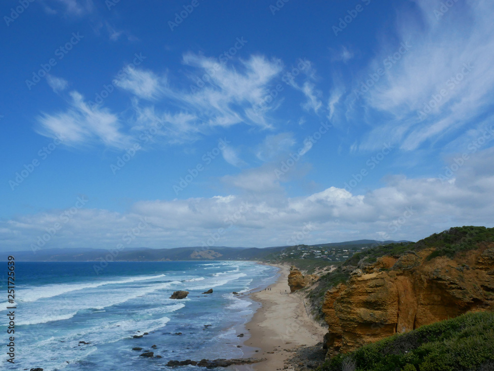 A beach landscape with bright blue sky and clouds along the gold coast of Southern Australia
